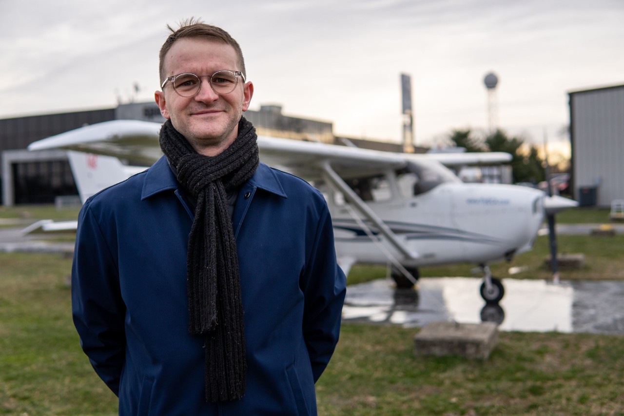 UC Clermont aviation graduate Seth Cooper stands in front of plane